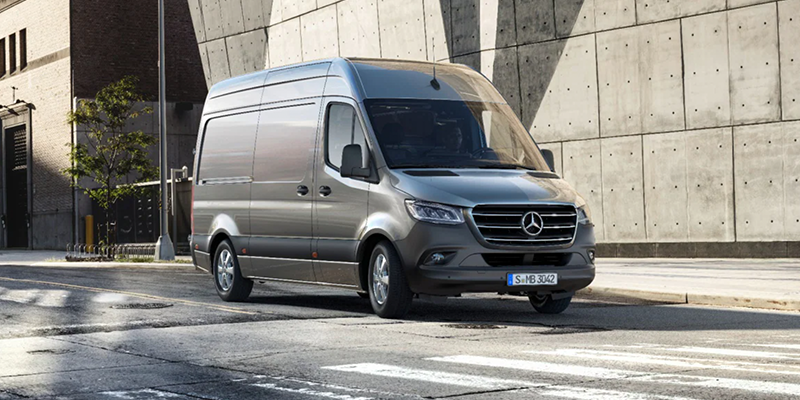 Silver Mercedes Sprinter van parked on city street