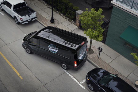Black Ford Transit cargo van parking on street Black Ford Transit cargo van parking on street